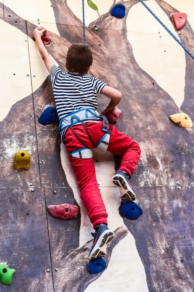 boy climbing wall